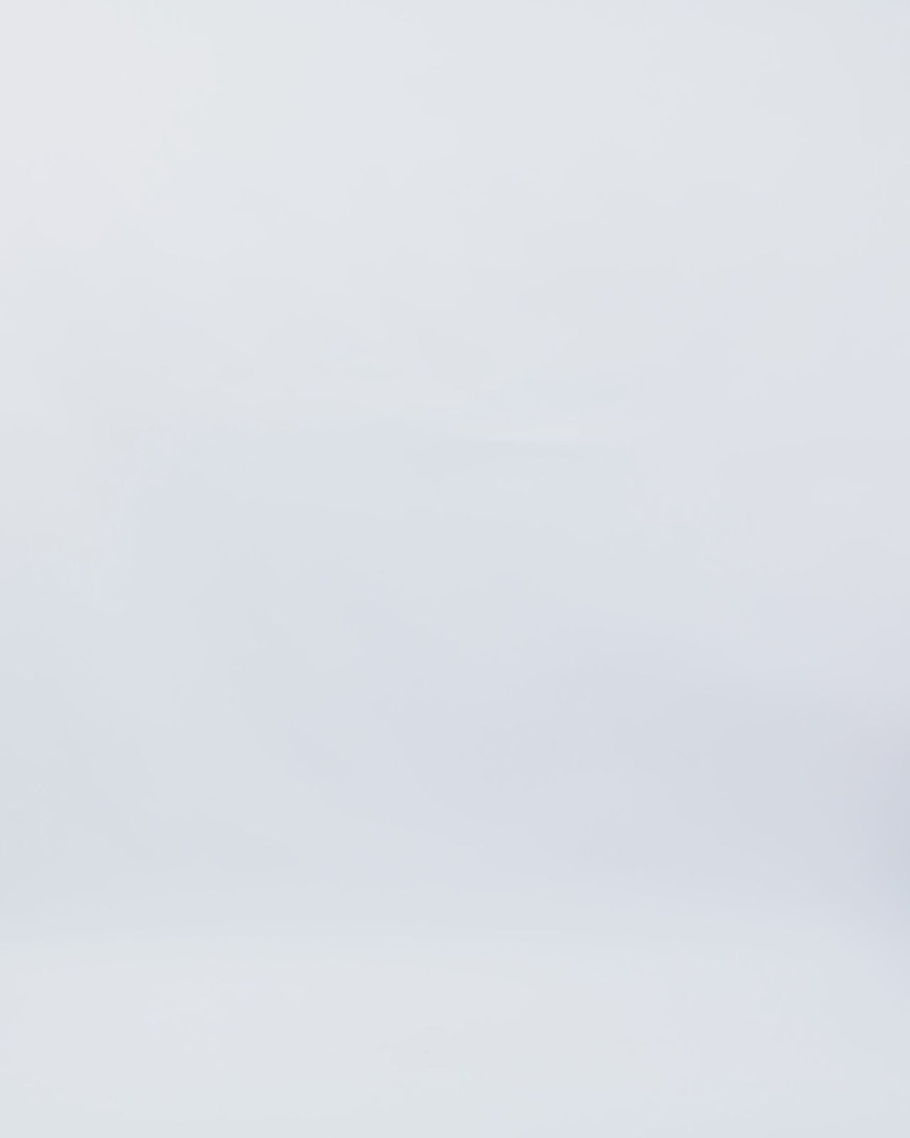 A slim-cut champagne evening dress featuring a strapless boat neckline with a detachable collar, beadings on the corset, and slits on the side.