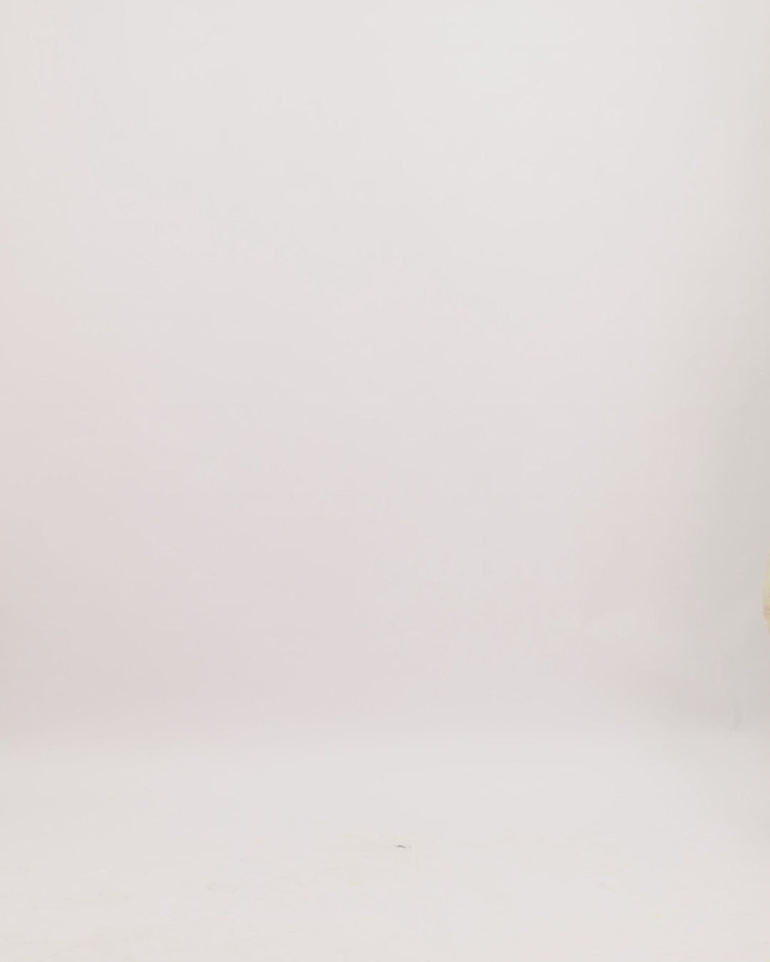 A fully beaded asymmetrical neckline evening dress with long sleeves and a slit on the side.