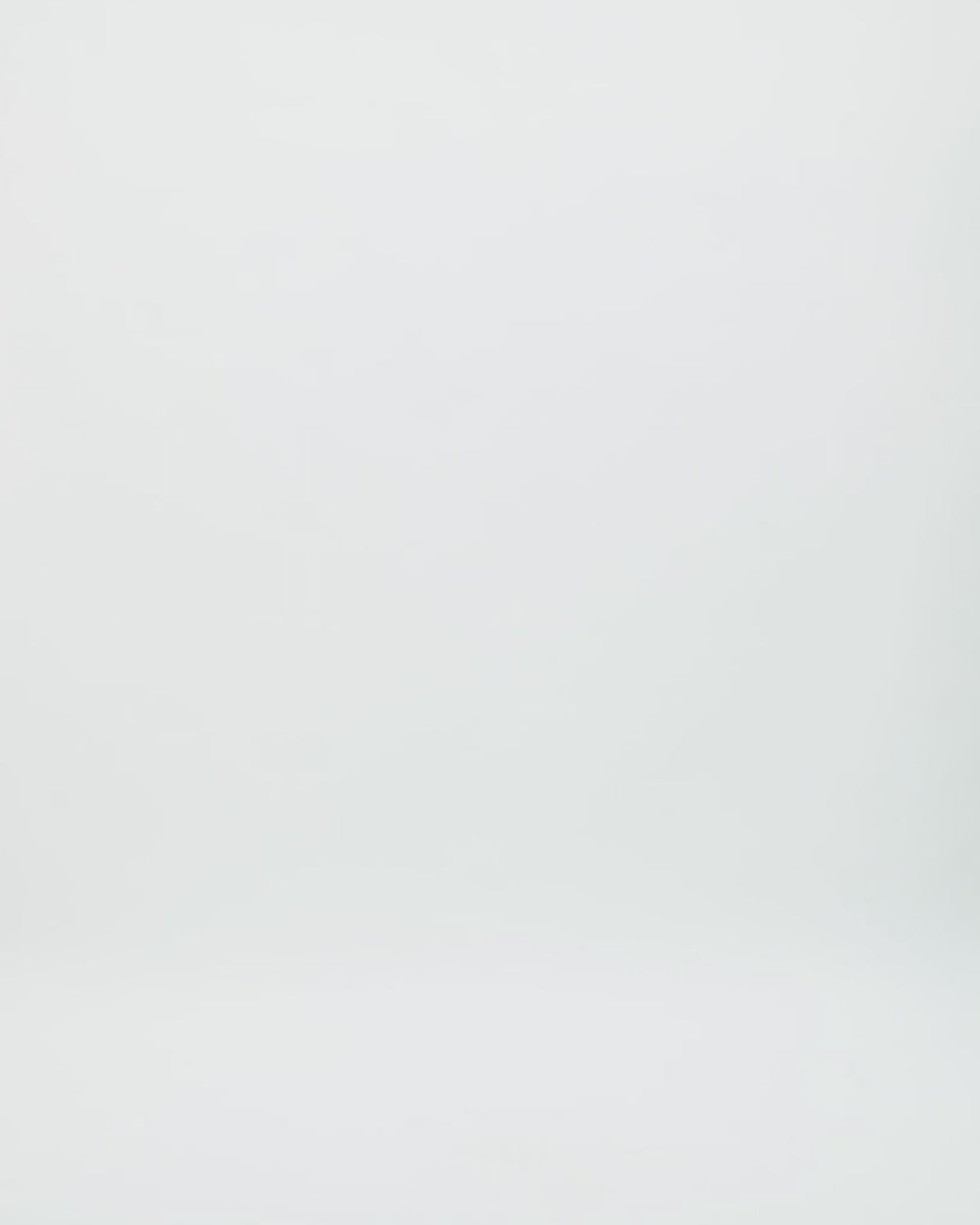 Video showcasing a sleeveless navy evening gown with a sheer, intricately beaded bodice and a floor-length pleated satin skirt. The dress features a high neckline in the front and a deep scoop back adorned with matching beadwork, highlighting its elegant movement and luxurious texture as the model turns.