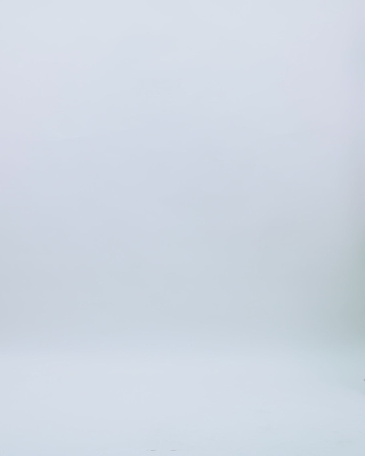 A halter neckline full sequins evening dress in green with draping details and a slit at the front.