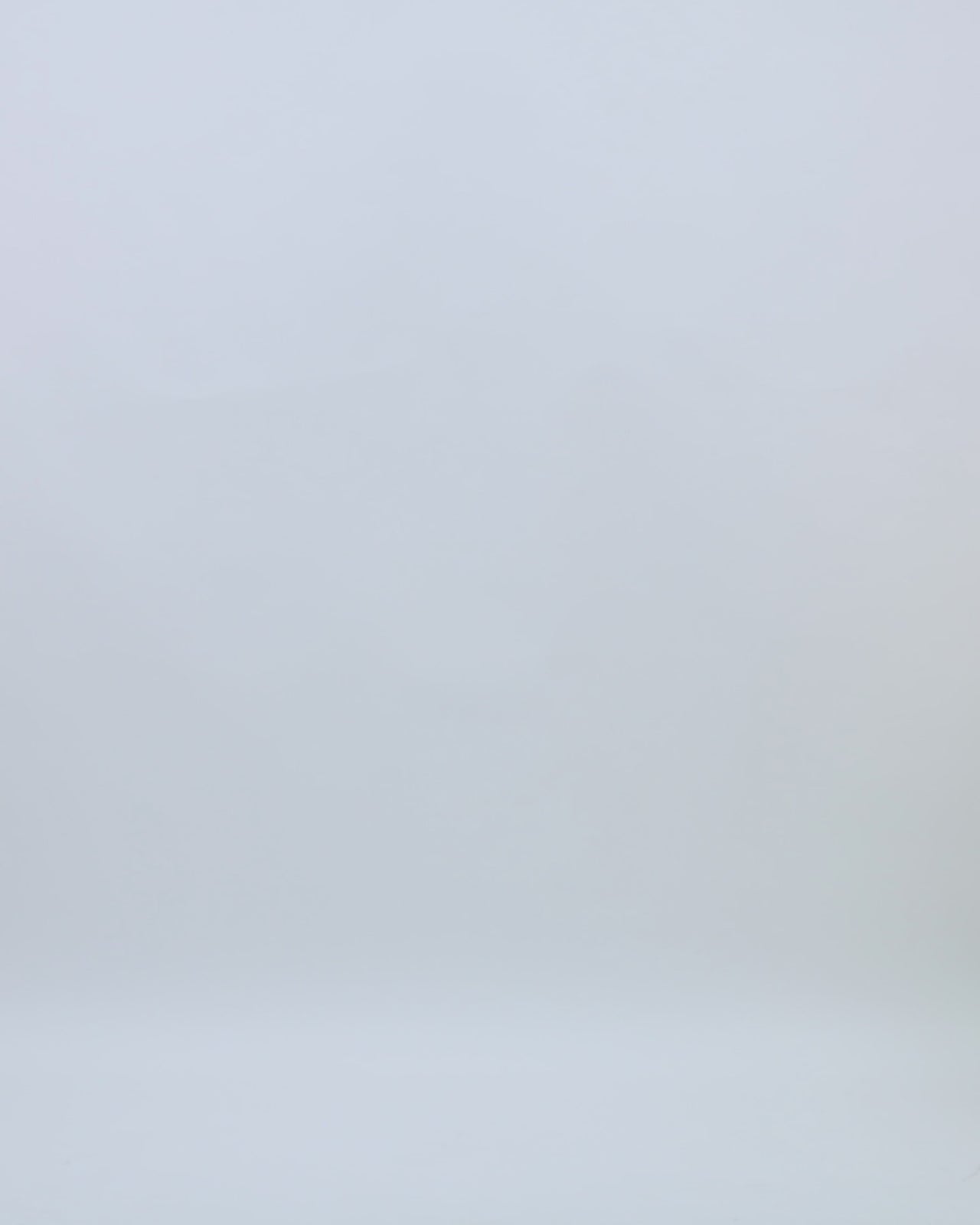 A v-neckline evening dress in yellow organza lamé with draping details on the side and an open slit.