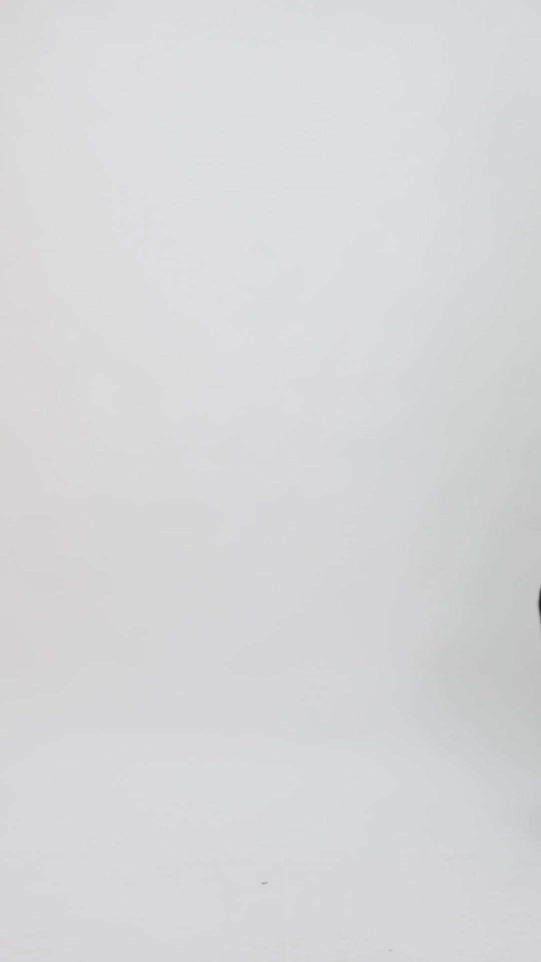 A black evening wear set featuring a tube top with a beaded tulle overlay paired with straight-cut pants with slits on the sides.