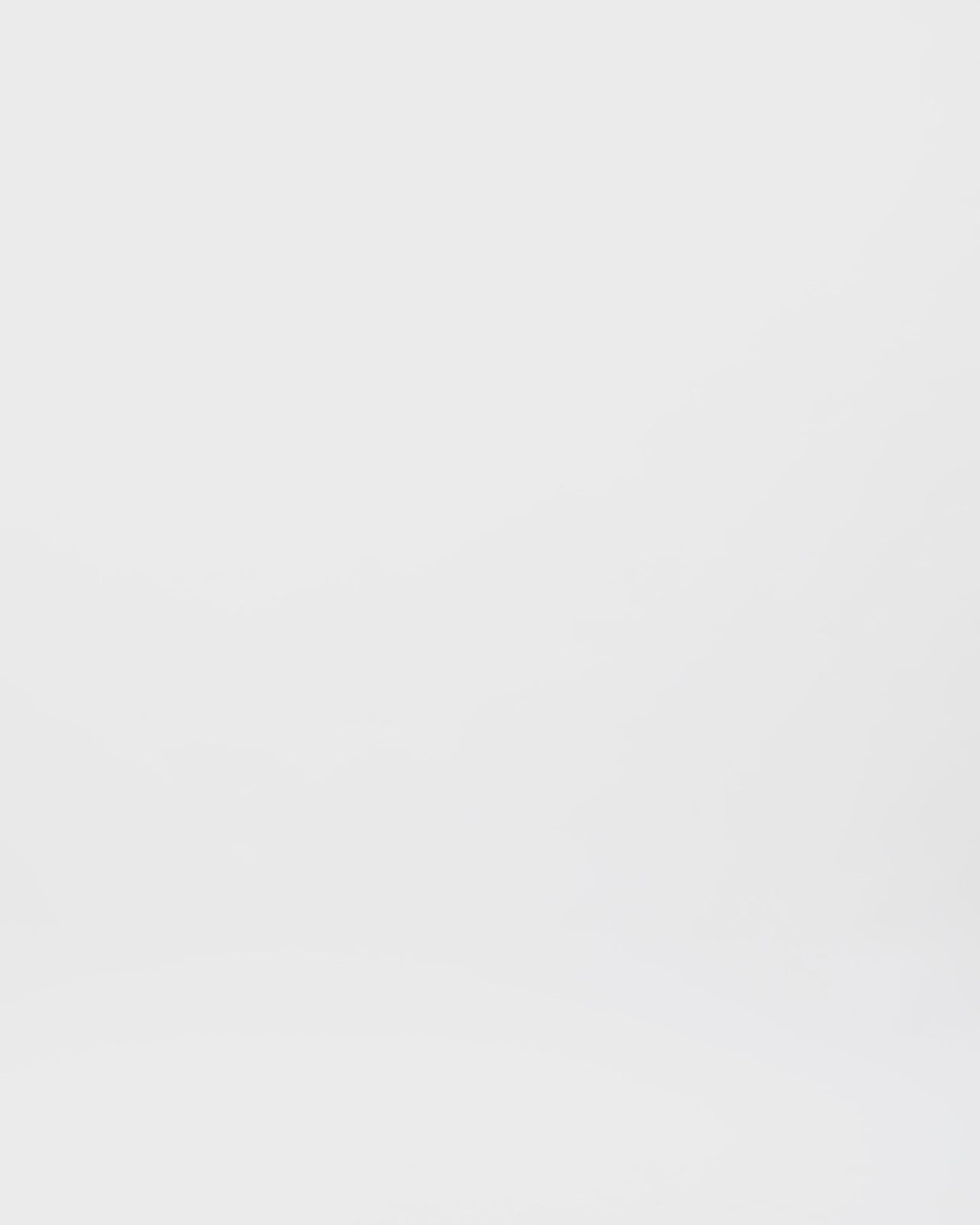 An asymmetrical draped navy evening dress with a ruffled sleeve going all the way down to the hemline and a slit on the side.