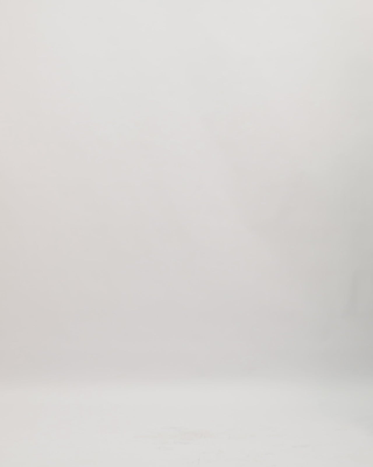 An off-the-shoulders loose-cut black lace evening dress with organza details on the neckline.