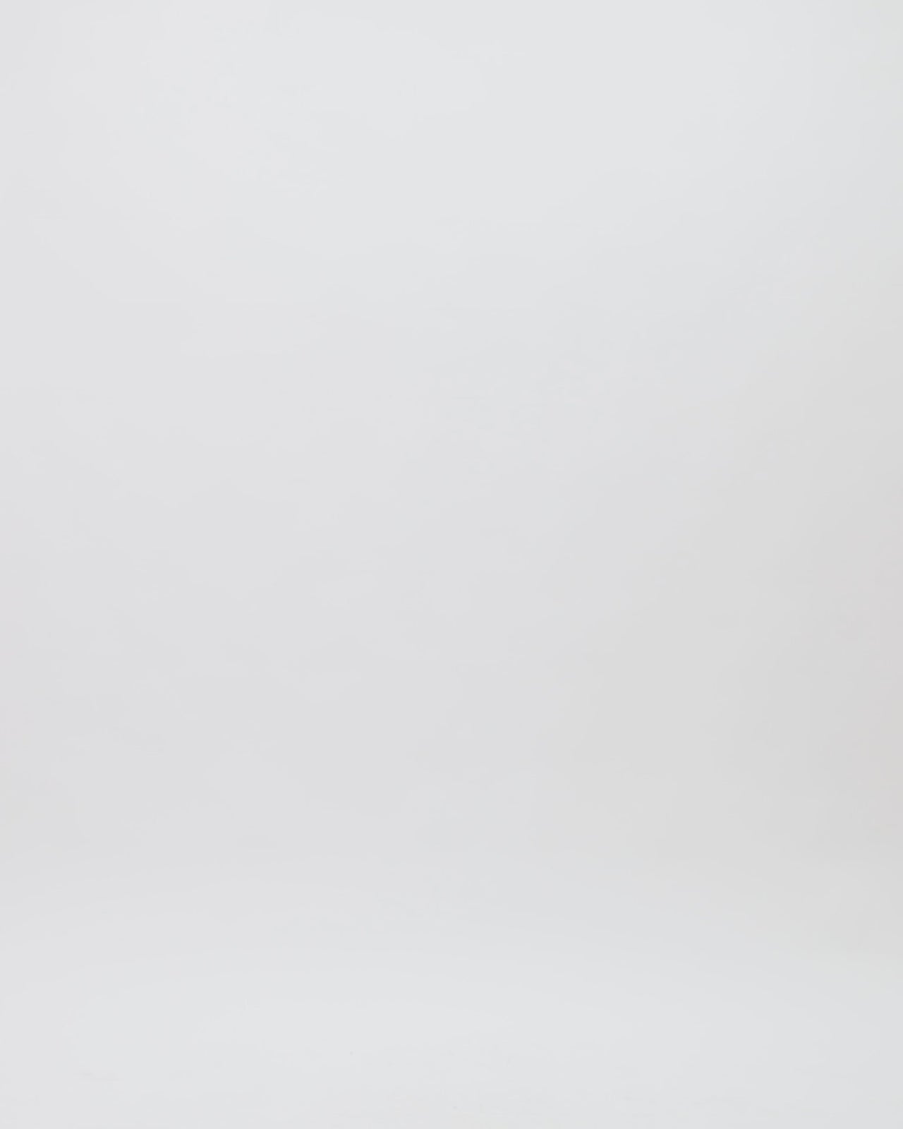 A draped copper evening dress featuring an asymmetrical neckline and hemline, and a slit on the side.