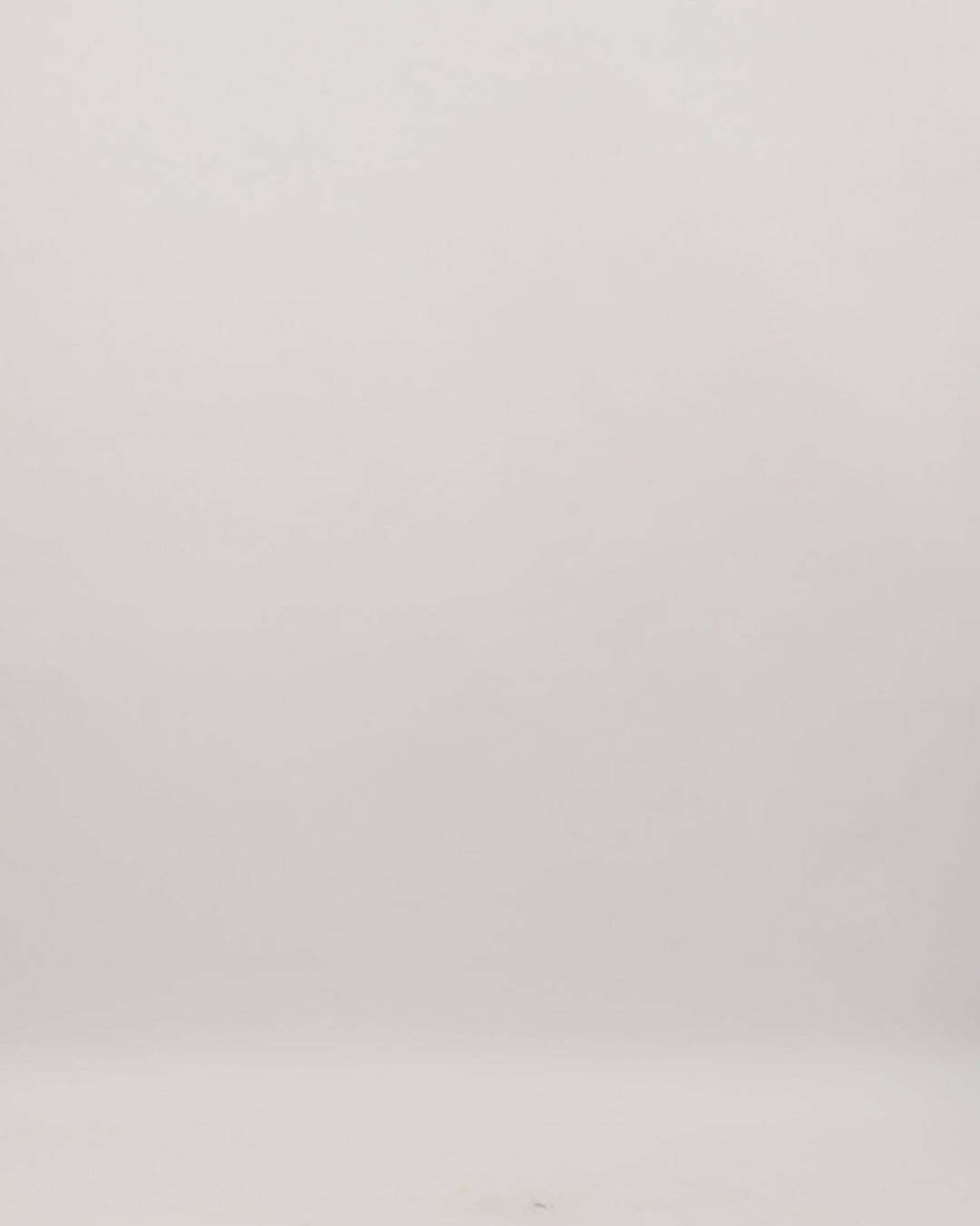 A black strapless evening dress featuring an embroidered satin top with an asymmetrical hemline, paired with a short tulle skirt.