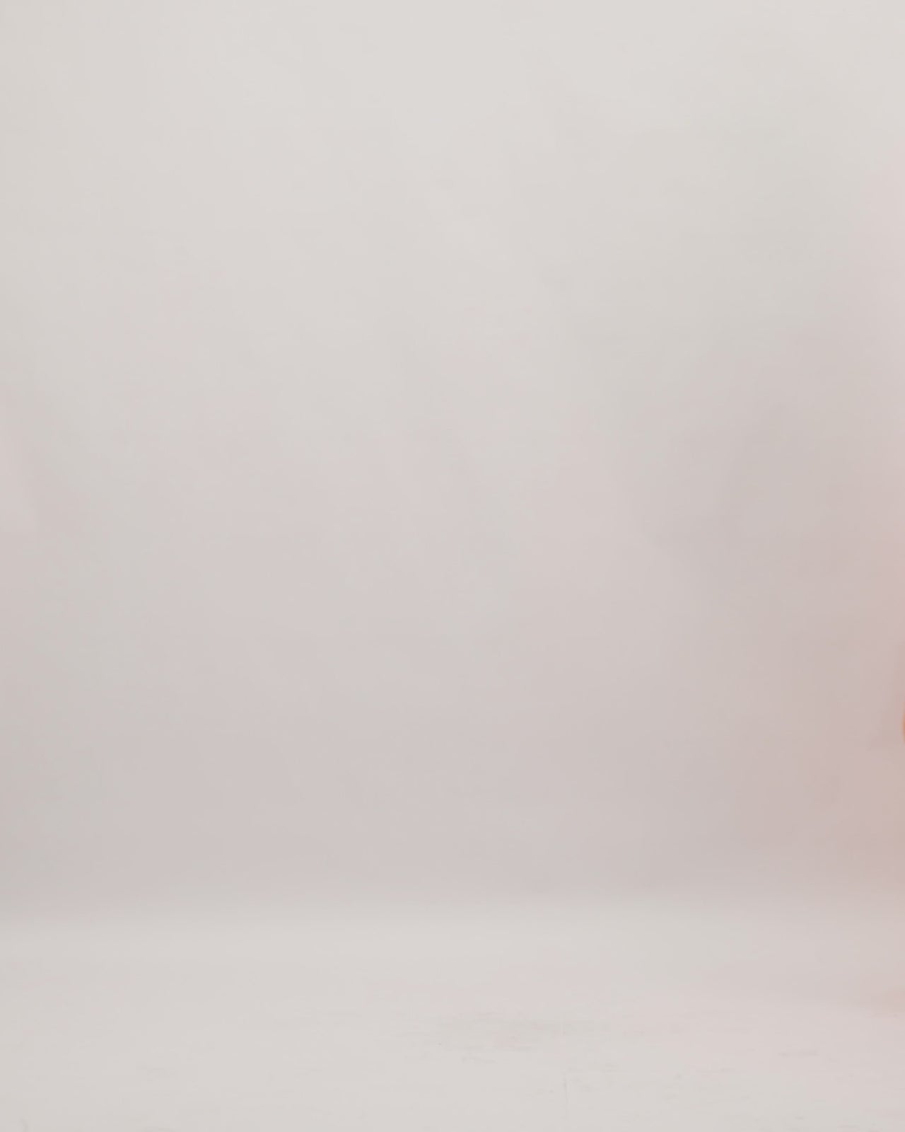 A one-shoulder evening dress in orange jacquard fabric with draping on the waistline, a slit on the side and an asymmetrical open back.