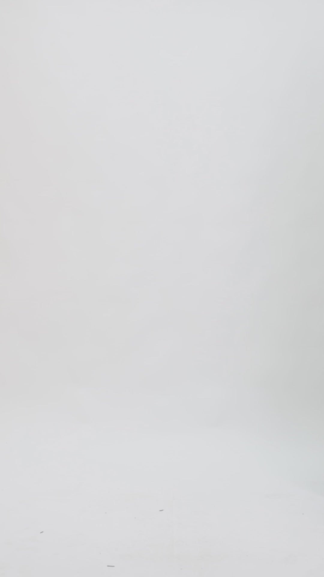 A black evening wear set featuring a draped loose top with a draped florals on the shoulder paired with a straight-cut pants with slits on the sides.