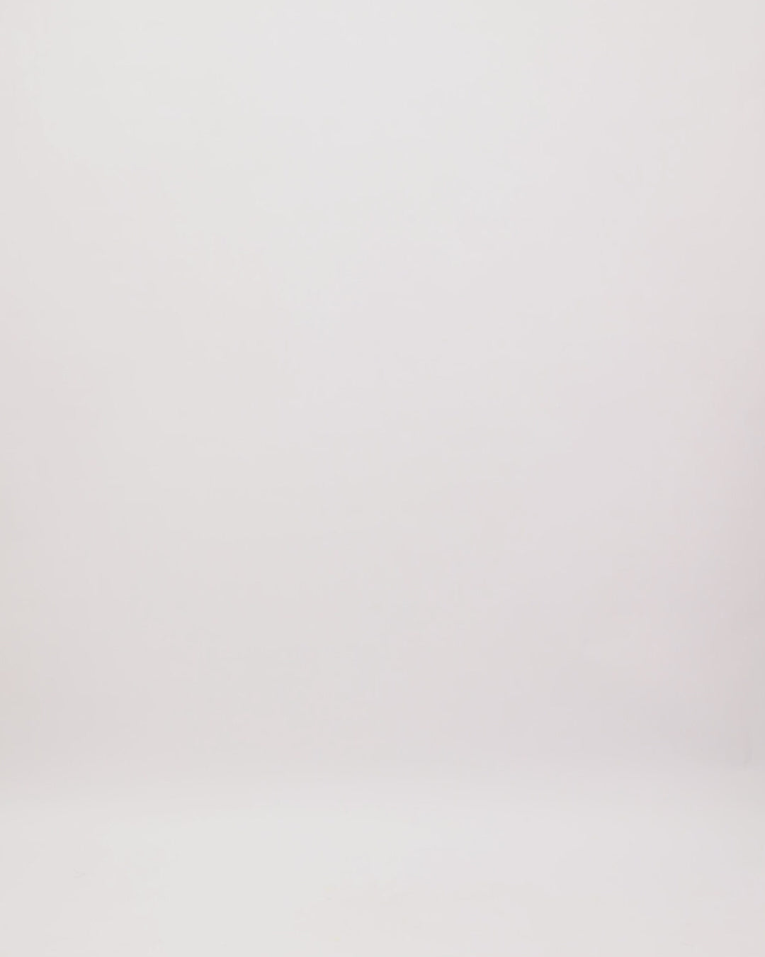 The back of an off-the-shoulders evening dress in dusty pink featuring a draped corset and waistline, and beaded sleeves.