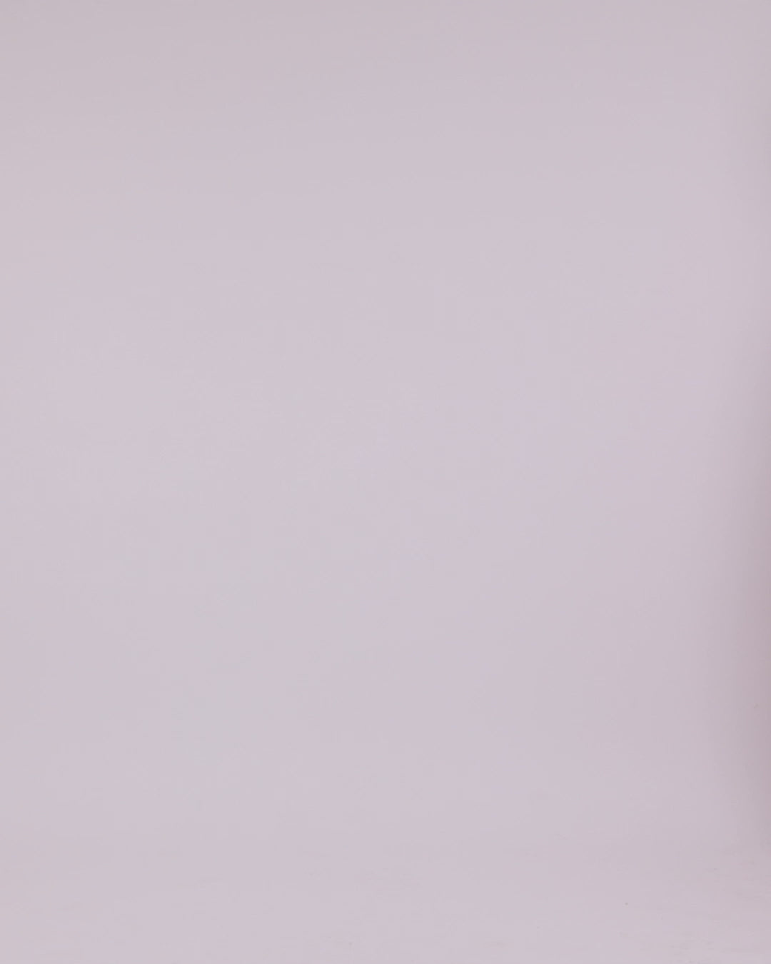 An asymmetrical V-neckline, red evening dress with draping details, and a long cape-like sleeves.