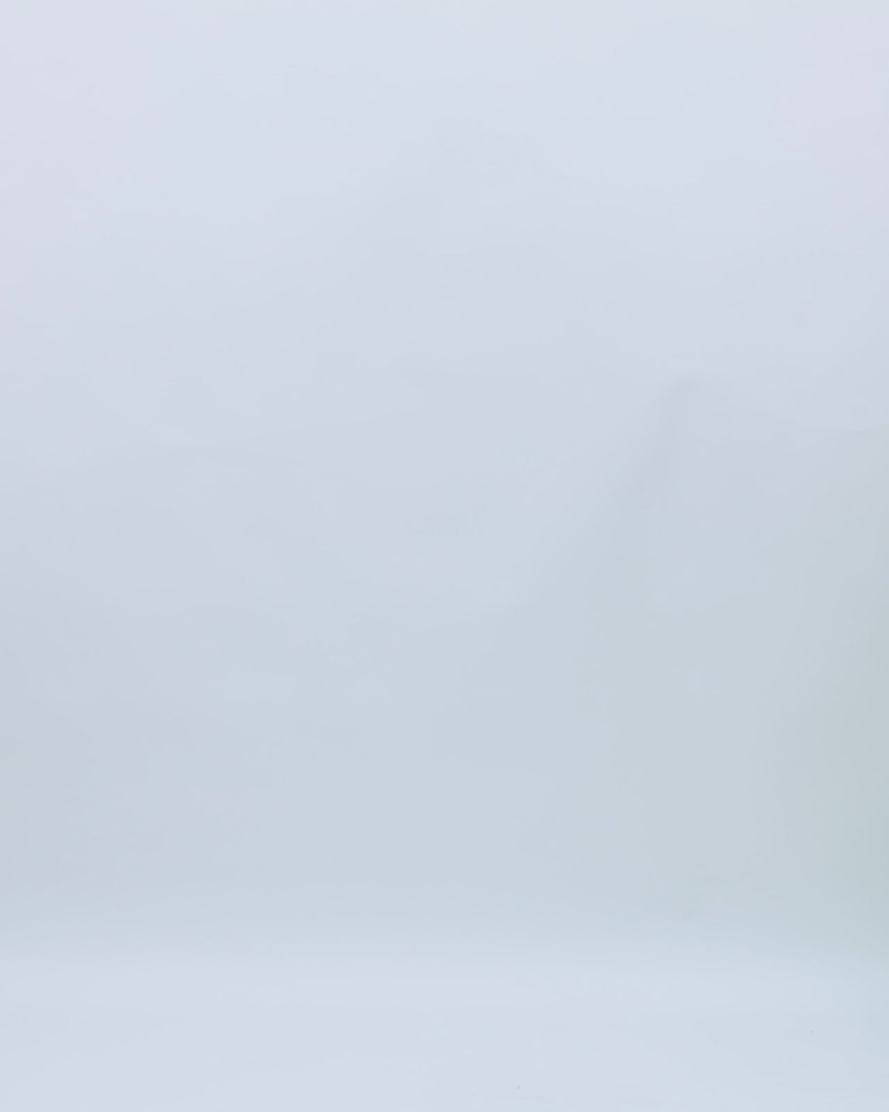 A one-shoulder green evening dress with draping details and beadings on the waistline.