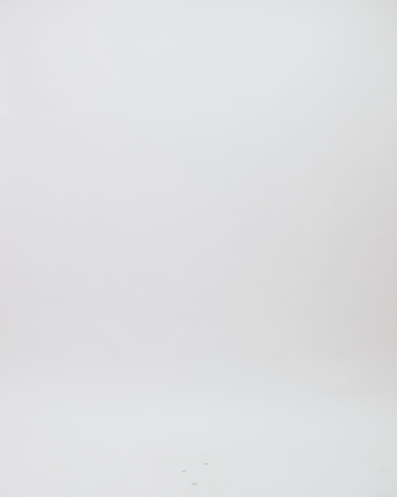 A v-neckline draped shiny tulle evening dress in copper color with asymmetrical sleeves and gathered back.