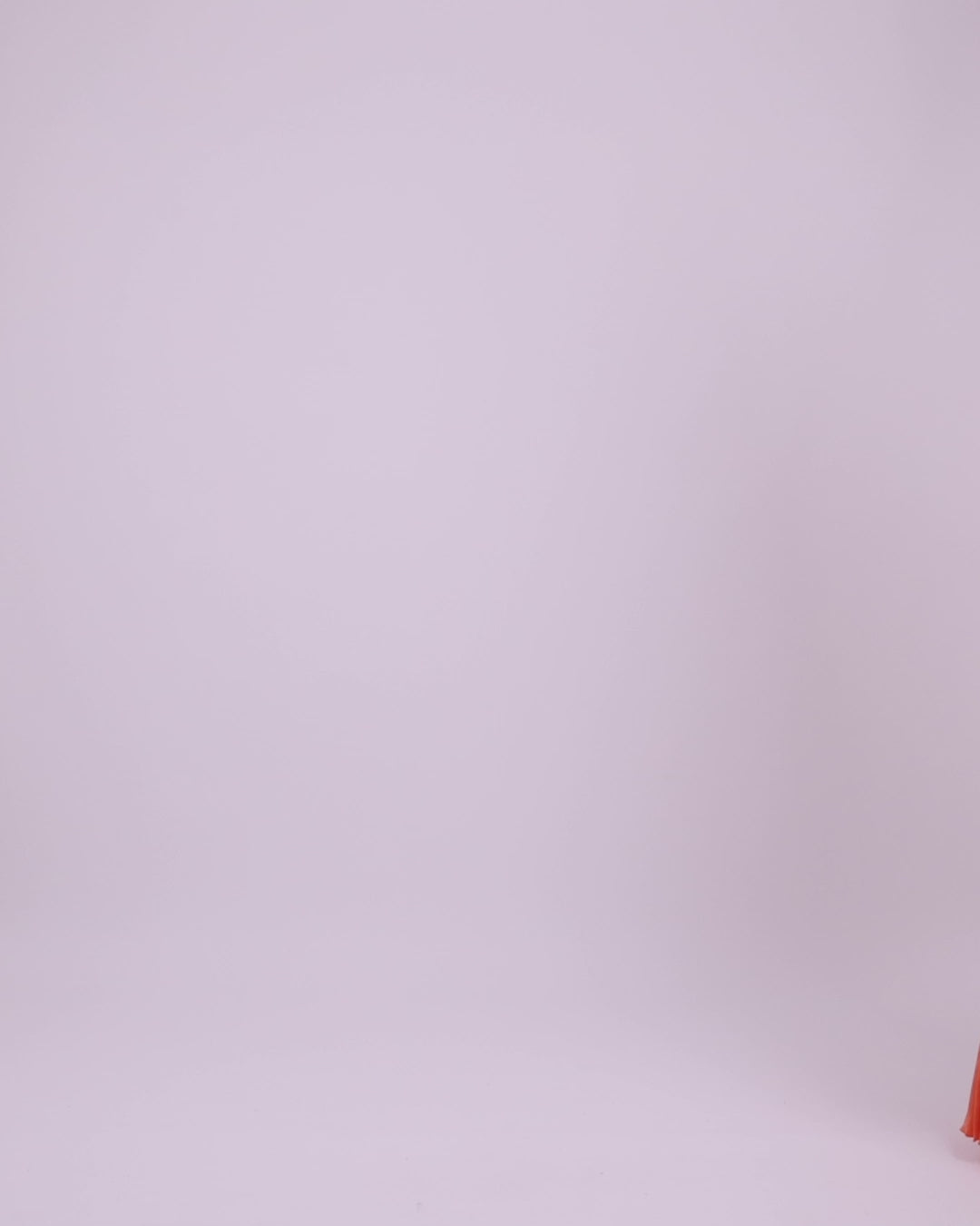 A fully pleated soft lame organza long flared dress with an asymmetrical long cape-like sleeves.